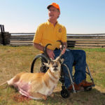 Hunter in wheelchair poses displaying his trophy