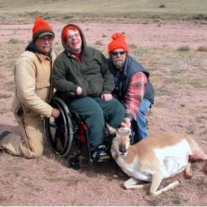 Group of hunters pose in front of their trophy