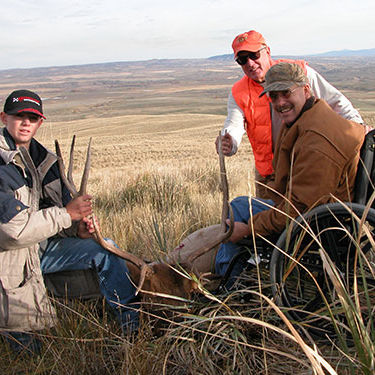 Trio of hunters posing with their trophy