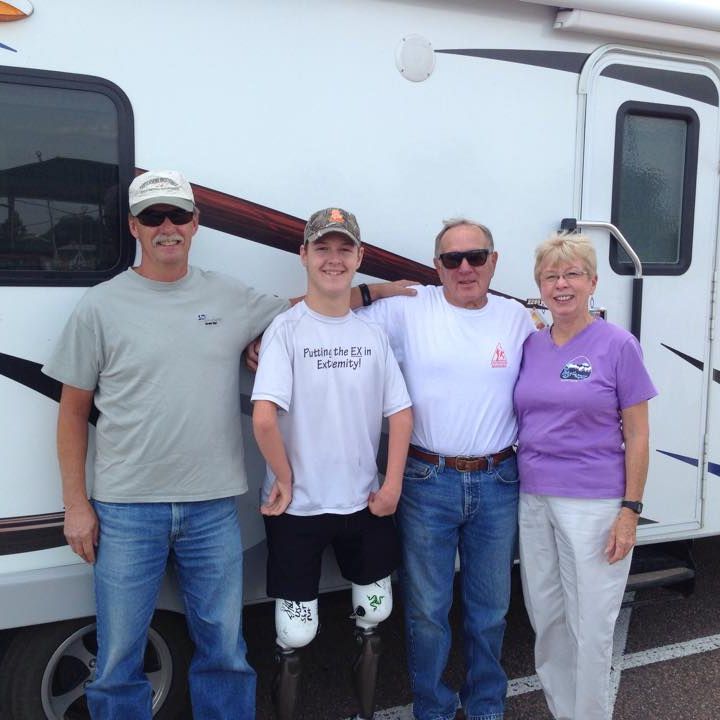 Group of individuals posing in front of an RV
