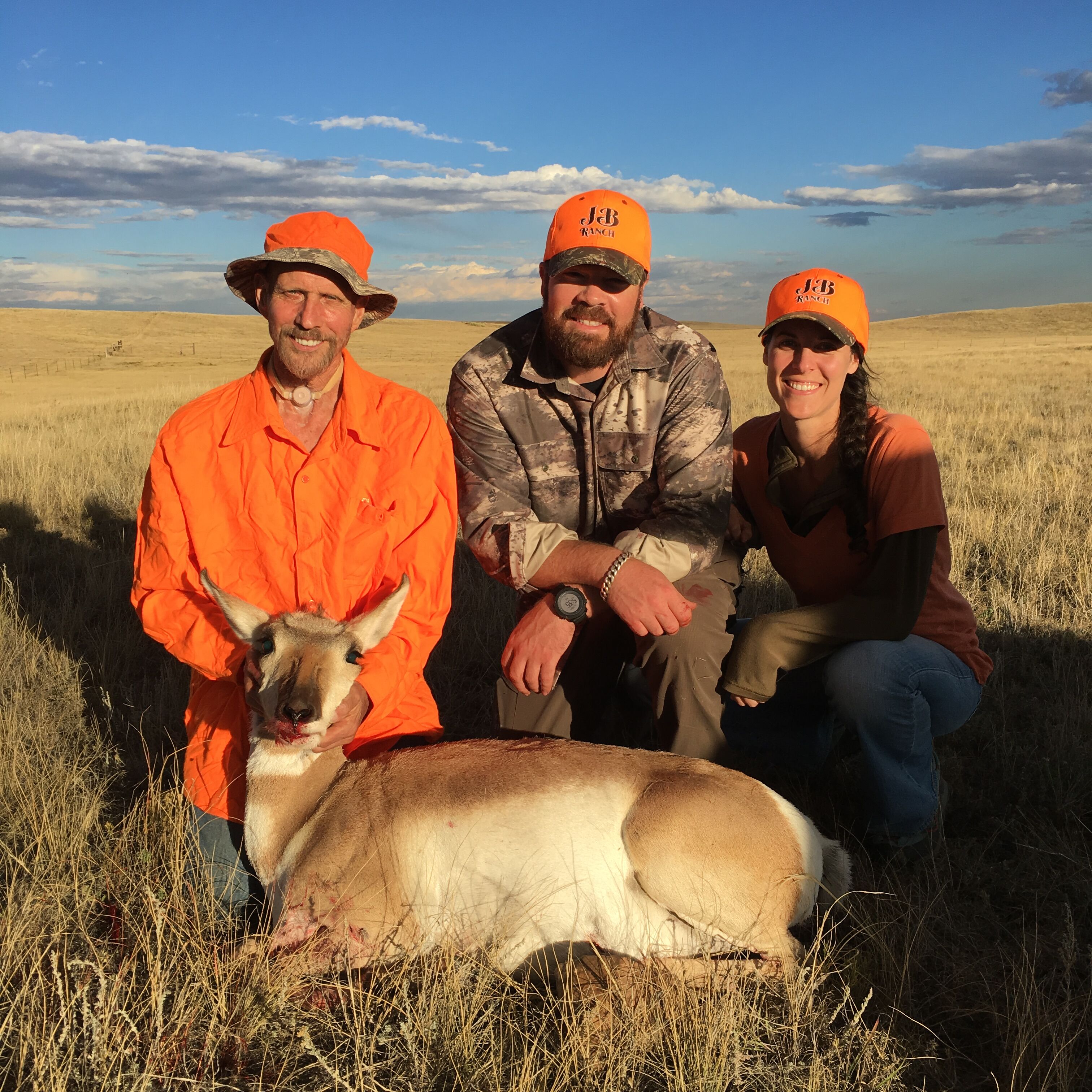 Group of hunters pose in front of their trophy