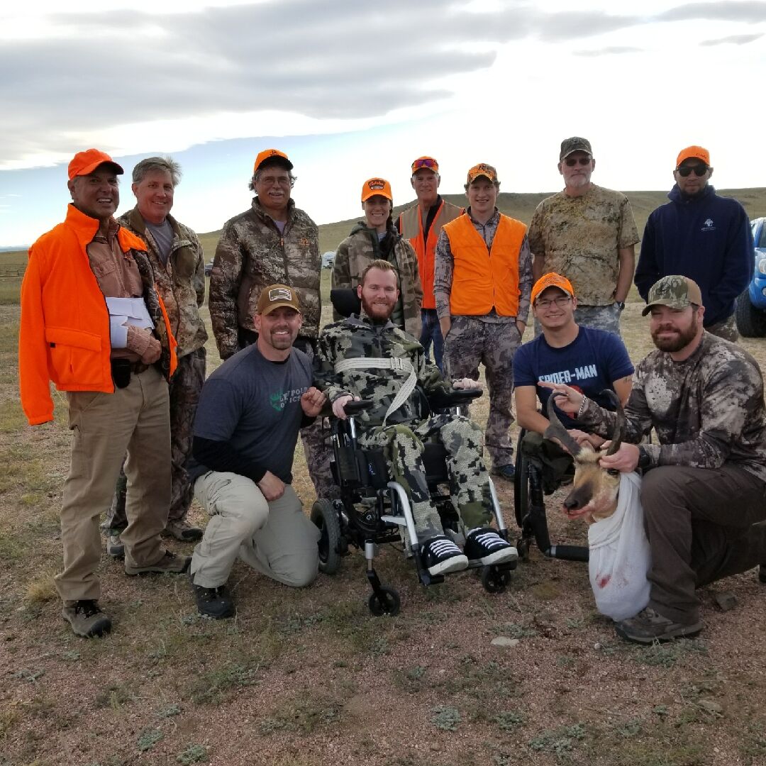 Group of hunters posing in front of their trophy