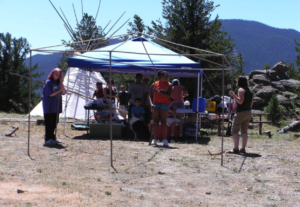 Group of people setting up a tent